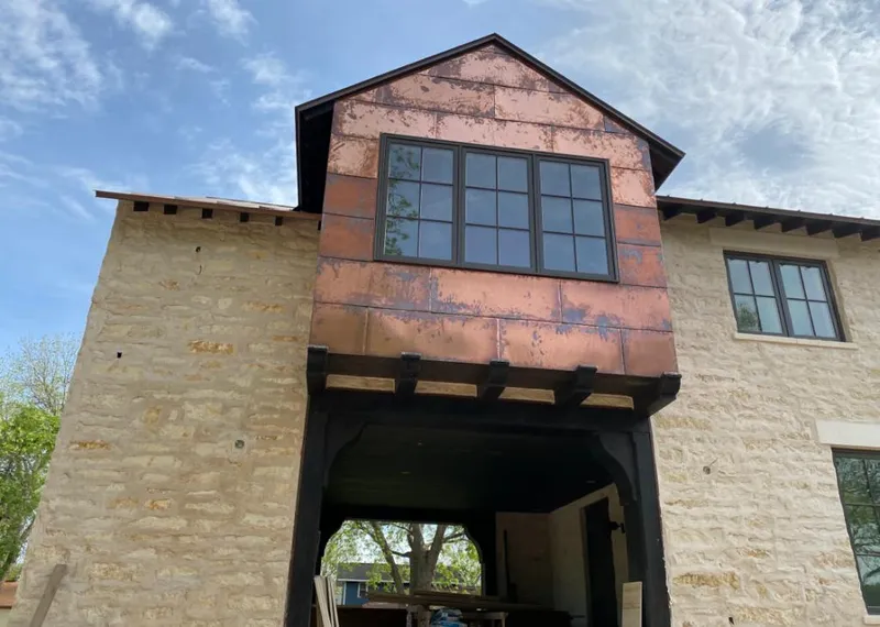 Copper metal panel facade on a stone building for Skylight Installation in Lakeport